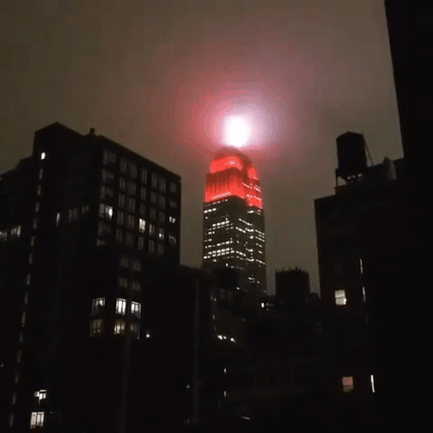 The Empire State Building lit red to remind New Yorkers to stay home - Insider (1).gif
